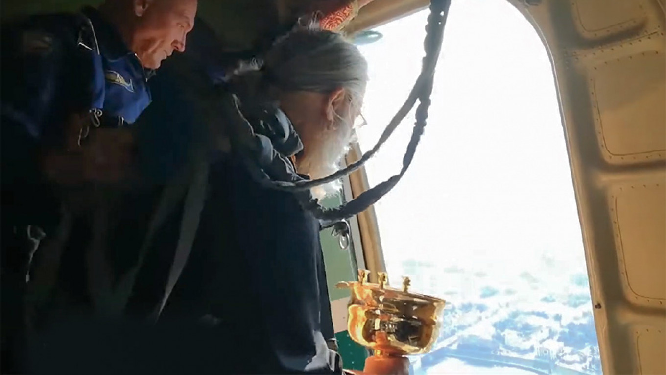 Padres despejam água benta de avião para curar a cidade da dependência de álcool e drogas